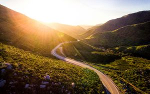 Preview wallpaper mountains, road, serpentine, sunset