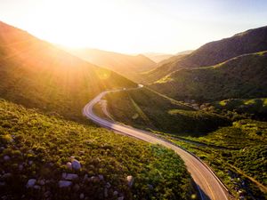 Preview wallpaper mountains, road, serpentine, sunset