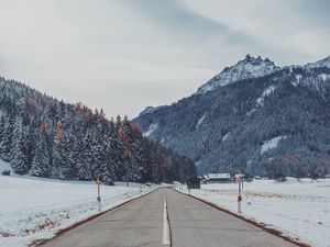 Preview wallpaper mountains, road, snow, marking, trees