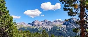 Preview wallpaper mountains, rocks, branches, trees, sky, clouds