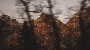 Preview wallpaper mountains, rocks, brown, trees, blur