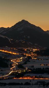 Preview wallpaper mountains, rocks, city, lights, snow