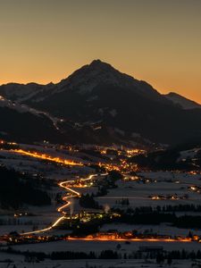 Preview wallpaper mountains, rocks, city, lights, snow