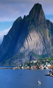 Preview wallpaper mountains, rocks, coast, sky, clouds, city, port, house