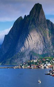 Preview wallpaper mountains, rocks, coast, sky, clouds, city, port, house