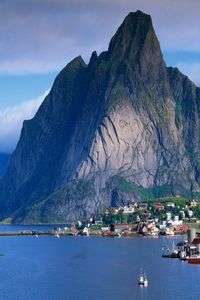 Preview wallpaper mountains, rocks, coast, sky, clouds, city, port, house