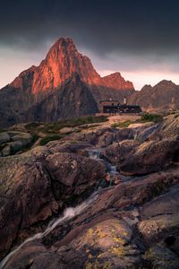 Preview wallpaper mountains, rocks, house, stones, stream