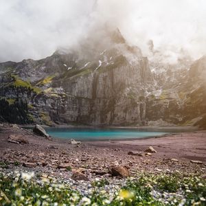 Preview wallpaper mountains, rocks, lake, fog, flowers