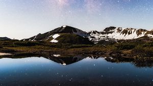 Preview wallpaper mountains, rocks, lake, reflection, night, snowy