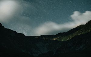 Preview wallpaper mountains, rocks, night, starry sky, stars, clouds