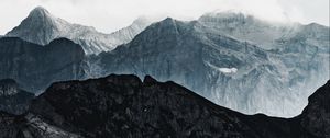 Preview wallpaper mountains, rocks, relief, snowy, clouds