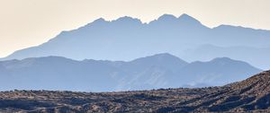 Preview wallpaper mountains, rocks, sand, grass, distance