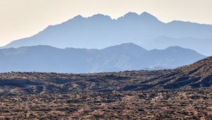 Preview wallpaper mountains, rocks, sand, grass, distance