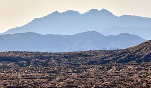 Preview wallpaper mountains, rocks, sand, grass, distance