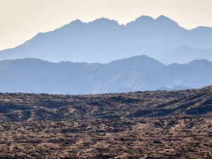 Preview wallpaper mountains, rocks, sand, grass, distance