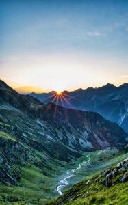 Preview wallpaper mountains, rocks, slope, rays, sky, sunrise, nature