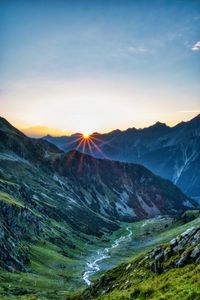 Preview wallpaper mountains, rocks, slope, rays, sky, sunrise, nature