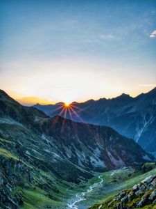 Preview wallpaper mountains, rocks, slope, rays, sky, sunrise, nature