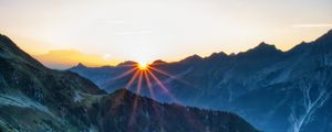 Preview wallpaper mountains, rocks, slope, rays, sky, sunrise, nature