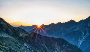 Preview wallpaper mountains, rocks, slope, rays, sky, sunrise, nature