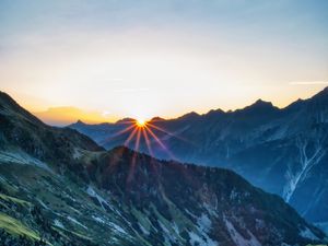 Preview wallpaper mountains, rocks, slope, rays, sky, sunrise, nature