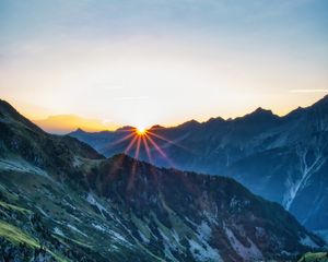 Preview wallpaper mountains, rocks, slope, rays, sky, sunrise, nature