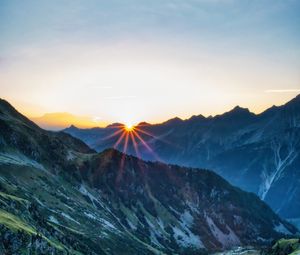 Preview wallpaper mountains, rocks, slope, rays, sky, sunrise, nature