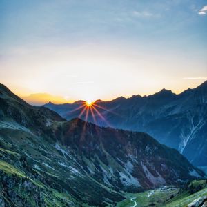 Preview wallpaper mountains, rocks, slope, rays, sky, sunrise, nature