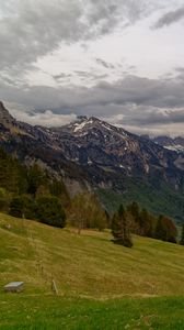 Preview wallpaper mountains, rocks, slope, grass, sky, clouds
