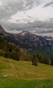 Preview wallpaper mountains, rocks, slope, grass, sky, clouds