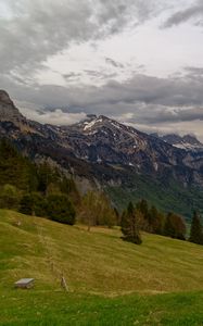 Preview wallpaper mountains, rocks, slope, grass, sky, clouds