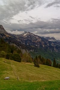 Preview wallpaper mountains, rocks, slope, grass, sky, clouds
