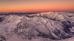 Preview wallpaper mountains, rocks, snow, snowy, sunset, sky
