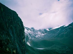 Preview wallpaper mountains, rocks, snow, snowy, grass, clouds