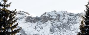 Preview wallpaper mountains, rocks, snow, snowy, spruce, sky