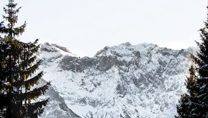 Preview wallpaper mountains, rocks, snow, snowy, spruce, sky