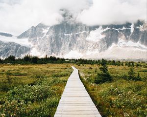 Preview wallpaper mountains, rocks, snowy, path, clouds
