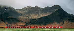 Preview wallpaper mountains, rocks, train, grass, fog