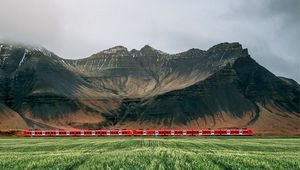 Preview wallpaper mountains, rocks, train, grass, fog