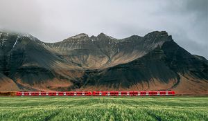 Preview wallpaper mountains, rocks, train, grass, fog