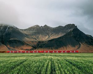 Preview wallpaper mountains, rocks, train, grass, fog