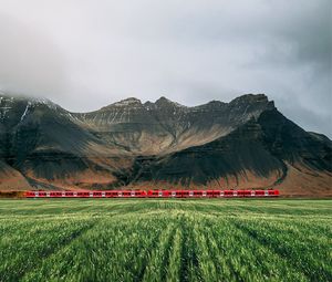 Preview wallpaper mountains, rocks, train, grass, fog