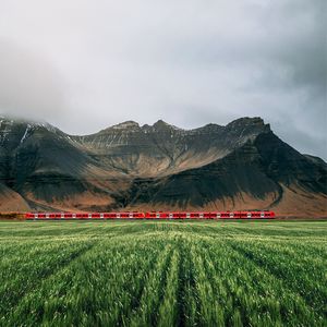 Preview wallpaper mountains, rocks, train, grass, fog