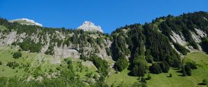 Preview wallpaper mountains, rocks, trees, slope, sky, nature