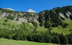 Preview wallpaper mountains, rocks, trees, slope, sky, nature