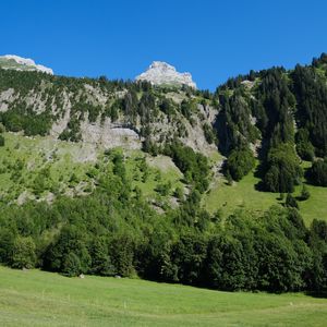 Preview wallpaper mountains, rocks, trees, slope, sky, nature