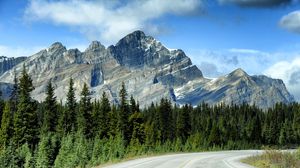 Preview wallpaper mountains, rocks, trees, spruce, sky, road