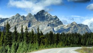 Preview wallpaper mountains, rocks, trees, spruce, sky, road