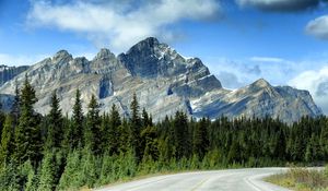 Preview wallpaper mountains, rocks, trees, spruce, sky, road