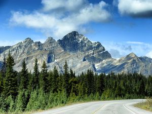 Preview wallpaper mountains, rocks, trees, spruce, sky, road